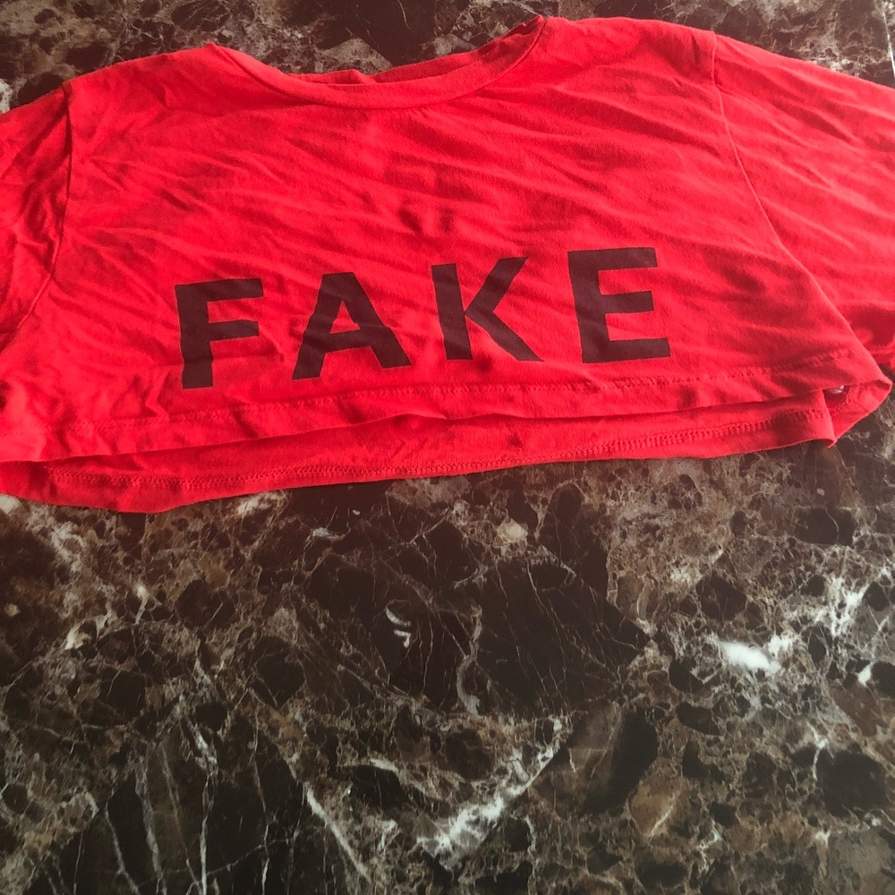 Red “Fake” graphic crop top
